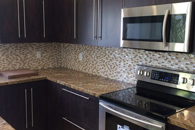 Mid-sized elegant l-shaped cement tile floor and beige floor kitchen photo in Miami with flat-panel cabinets, dark wood cabinets, granite countertops, multicolored backsplash, mosaic tile backsplash and an island