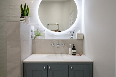 Design ideas for a medium sized contemporary bathroom in Other with shaker cabinets, green cabinets, a walk-in shower, a wall mounted toilet, white tiles, slate tiles, white walls, slate flooring, a built-in sink, white floors, an open shower, white worktops, feature lighting, a single sink and a built in vanity unit.