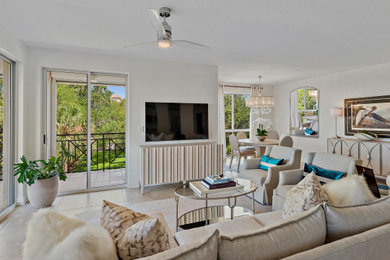 Example of a huge beach style open concept porcelain tile and beige floor family room design in Tampa with white walls