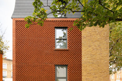 Red modern brick terraced house in London.