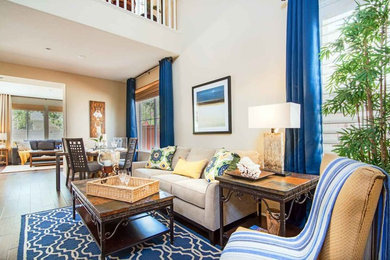 Example of a beach style medium tone wood floor living room design in Los Angeles with beige walls