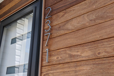 Example of a minimalist wood exterior home design in Cleveland