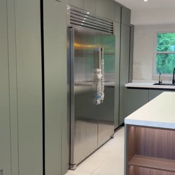 Built-in Stainless Steel Refrigerator & Sage Green Floor-to-Ceiling Cabinet Wall