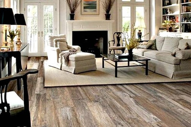 Living room - mid-sized transitional formal and open concept medium tone wood floor living room idea in Orlando with gray walls, a standard fireplace, a tile fireplace and no tv