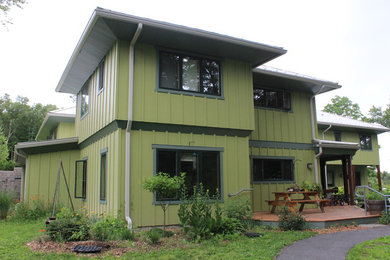 Huge transitional green two-story wood exterior home photo in New York