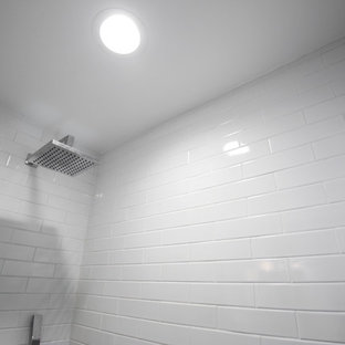Example of a small trendy white tile and subway tile ceramic floor and turquoise floor bathroom design in Los Angeles with medium tone wood cabinets, a one-piece toilet, white walls, a vessel sink, quartzite countertops and white countertops
