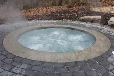 Inspiration for a small modern backyard round pool remodel in Detroit