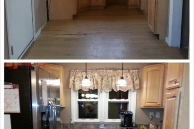 Eat-in kitchen - small contemporary galley eat-in kitchen idea in Baltimore with light wood cabinets, laminate countertops, stainless steel appliances and no island
