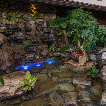Custom Rock Waterfall Pool with Stone Grotto, Stream and Tiki Hut