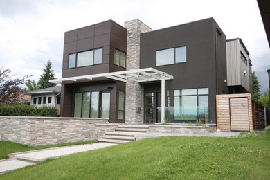 Inspiration for a contemporary brown two-story mixed siding flat roof remodel in Calgary