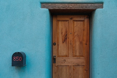 Small southwest blue one-story adobe house exterior photo in Other with a mixed material roof
