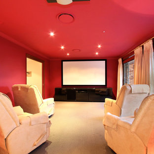 Elegant carpeted home theater photo in Wollongong with red walls