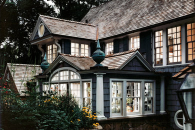Mid-sized traditional blue two-story wood exterior home idea in New York with a tile roof