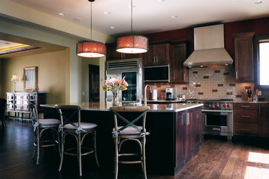 Open concept kitchen - large rustic l-shaped medium tone wood floor open concept kitchen idea in Denver with an island and stainless steel appliances