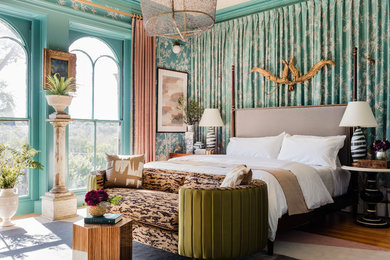 Photo of an eclectic bedroom in Boston with green walls, medium hardwood floors and brown floor.