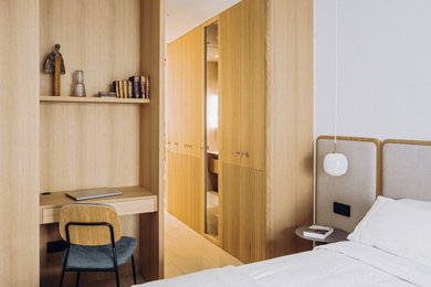 Diseño de dormitorio principal y blanco y madera nórdico de tamaño medio con paredes blancas, suelo de madera clara, suelo beige, panelado y con escritorio