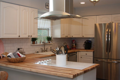Kitchen - shabby-chic style dark wood floor kitchen idea in Houston with a single-bowl sink, wood countertops and white backsplash