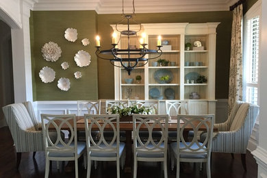 Inspiration for a mid-sized dark wood floor and brown floor enclosed dining room remodel in Jacksonville with green walls and no fireplace