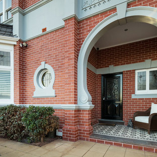 Design ideas for a traditional entryway in Melbourne with a single front door and a black front door.