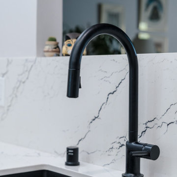 Countertop and full height backsplash is Cambria's Inverness Platinum