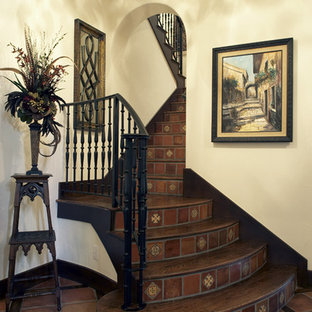 Medium sized mediterranean wood u-shaped metal railing staircase in Dallas with terracotta risers.