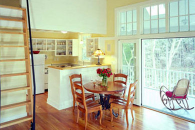 Small elegant medium tone wood floor great room photo in Other with yellow walls and no fireplace