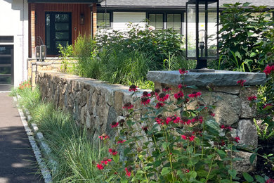 Design ideas for a mid-sized modern drought-tolerant and partial sun stone lawn edging in Boston for summer.