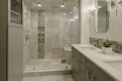 Design ideas for a mid-sized transitional master bathroom in Boston with flat-panel cabinets, grey cabinets, an alcove shower, a two-piece toilet, gray tile, ceramic tile, white walls, ceramic floors, an undermount sink, marble benchtops, grey floor and a hinged shower door.