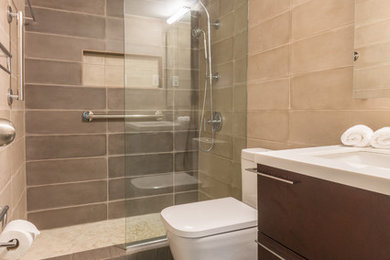 Example of a small minimalist 3/4 ceramic tile ceramic tile doorless shower design in DC Metro with louvered cabinets, dark wood cabinets, a one-piece toilet, beige walls, an undermount sink and quartzite countertops