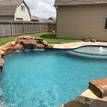 Cozy Lagoon pool with jump rocks and waterfall
