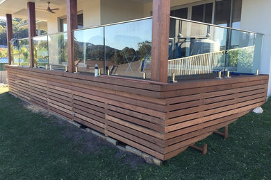 Photo of a small modern backyard deck in Gold Coast - Tweed with a pergola.