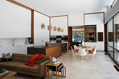 Design ideas for a large contemporary l-shaped eat-in kitchen in New York with a single-bowl sink, flat-panel cabinets, white cabinets, solid surface benchtops, white splashback, stainless steel appliances, ceramic floors and a peninsula.