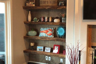 Inspiration for a mid-sized craftsman open concept ceramic tile and brown floor living room library remodel in Other with beige walls, a standard fireplace, a plaster fireplace and no tv