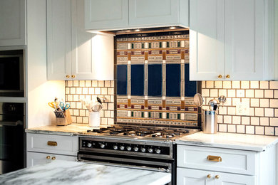 Trendy ceramic tile eat-in kitchen photo in Detroit with white cabinets, granite countertops, white backsplash, ceramic backsplash, stainless steel appliances and an island