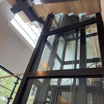 Project #136 | Modern Floating Staircase Encircling Glass Elevator