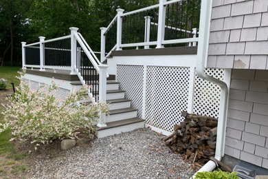 Deck - large transitional side yard second story mixed material railing deck idea in Providence