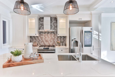 Inspiration for a mid-sized contemporary single-wall kitchen remodel in Los Angeles with a double-bowl sink, shaker cabinets, white cabinets, marble countertops, multicolored backsplash, mosaic tile backsplash, stainless steel appliances, an island and white countertops