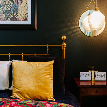 A luxurious master bedroom with gold framed bed