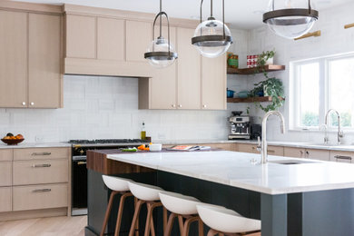 Inspiration for a large contemporary l-shaped light wood floor open concept kitchen remodel in Denver with a single-bowl sink, flat-panel cabinets, light wood cabinets, quartzite countertops, white backsplash, marble backsplash, stainless steel appliances, an island and white countertops