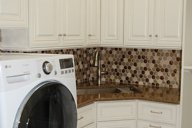 This is an example of a medium sized traditional u-shaped separated utility room in New Orleans with a built-in sink, beaded cabinets, white cabinets, granite worktops, white walls, ceramic flooring, a side by side washer and dryer and beige floors.