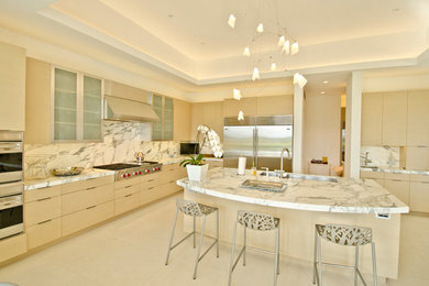 Large trendy u-shaped ceramic tile eat-in kitchen photo in Orange County with an undermount sink, flat-panel cabinets, light wood cabinets, marble countertops, stainless steel appliances and an island
