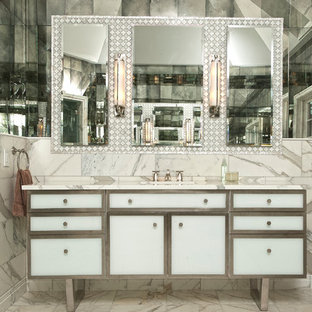 Cette photo montre une grande douche en alcôve principale tendance avec un lavabo encastré, un placard en trompe-l'oeil, des portes de placard blanches, un plan de toilette en marbre, une baignoire indépendante, un carrelage blanc, des carreaux de miroir, un mur blanc et un sol en carrelage de terre cuite.