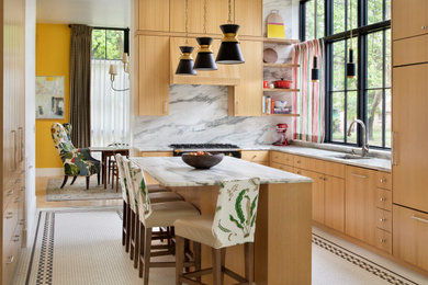 Example of a trendy u-shaped multicolored floor kitchen design in Other with an undermount sink, flat-panel cabinets, medium tone wood cabinets, white backsplash, stone slab backsplash, black appliances, an island and white countertops