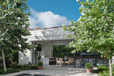 Transitional white one-story brick house exterior photo in Austin with a brown roof