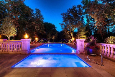 Pool fountain - large contemporary backyard rectangular natural pool fountain idea in Chicago