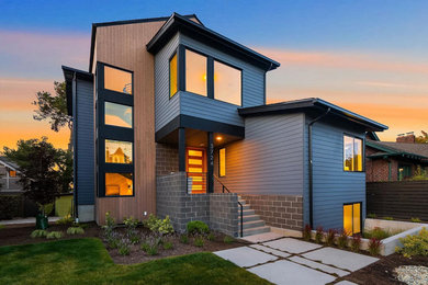 Inspiration for a large contemporary three-story concrete fiberboard and clapboard house exterior remodel in Seattle