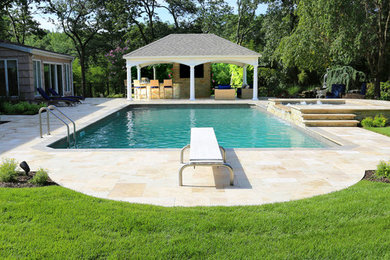 This is an example of a mid-sized contemporary backyard rectangular lap pool in Other with a hot tub and tile.