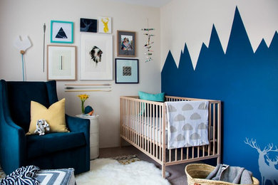 This is an example of a scandinavian nursery for boys in Sydney with blue walls and carpet.