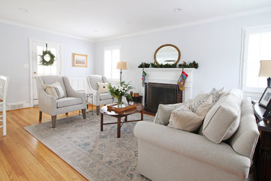 Living room - mid-sized farmhouse medium tone wood floor living room idea in DC Metro with blue walls and a standard fireplace