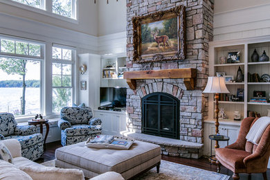 Large elegant open concept dark wood floor and brown floor living room photo in Minneapolis with beige walls, a standard fireplace, a stone fireplace and a tv stand